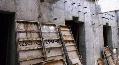 stripped formwork leaning on concrete wall